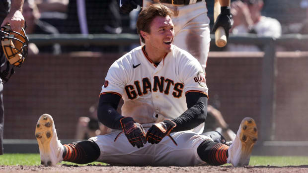 SF Giants center fielder Bryce Johnson sits on the ground after scoring a run against the Kansas City Royals. (2023)